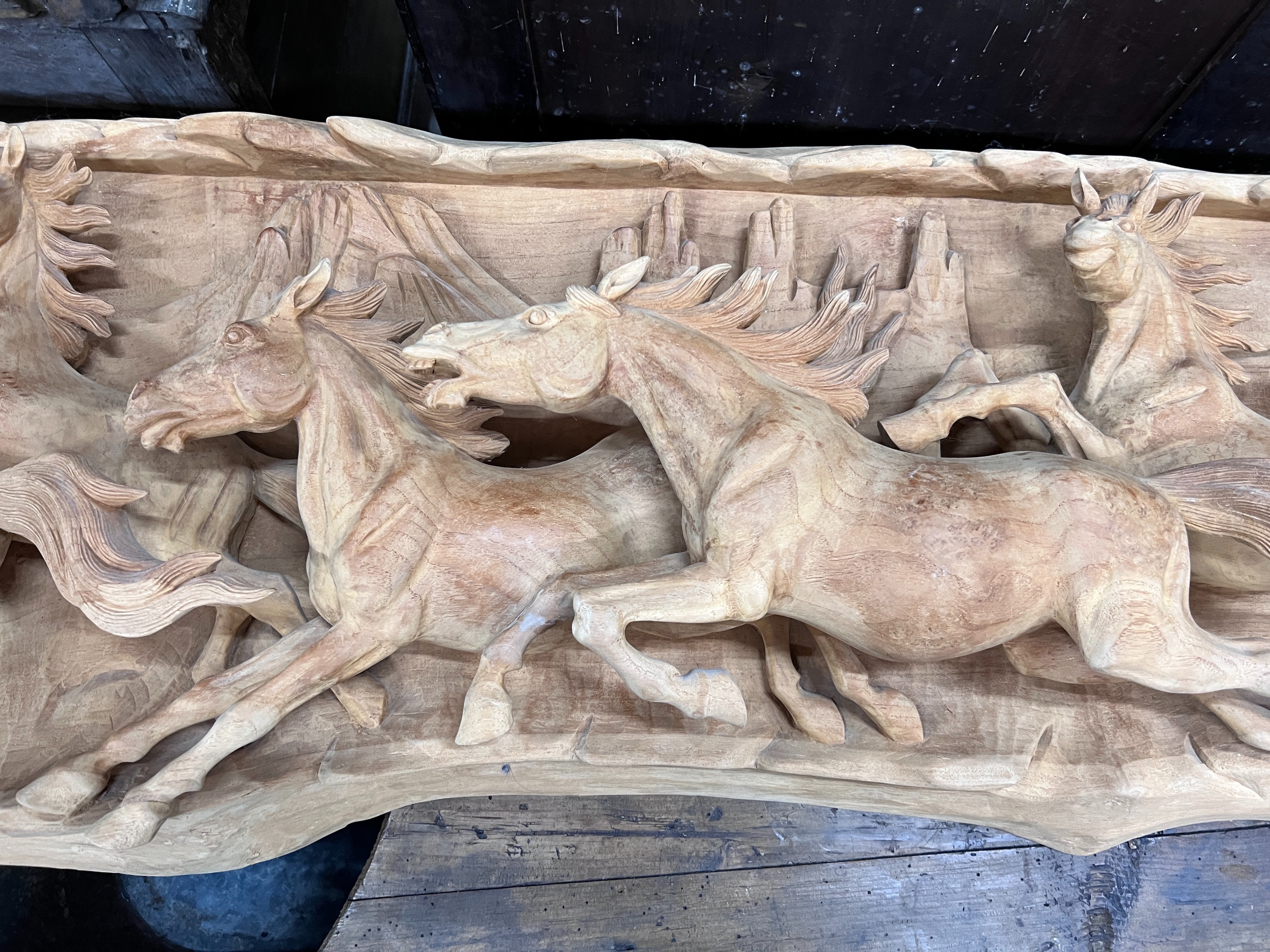 An unusual, probably American, carved wood panorama of eight galloping horses, width 200cm, height 46cm *Please note the sale commences at 9am.